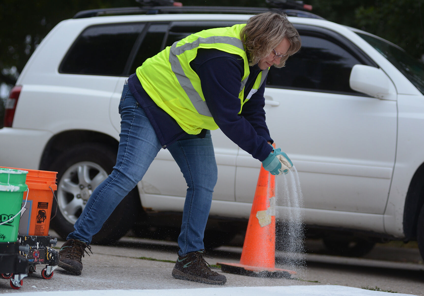 Tammy Irovic adds the final coat for the newly painted crosswalk